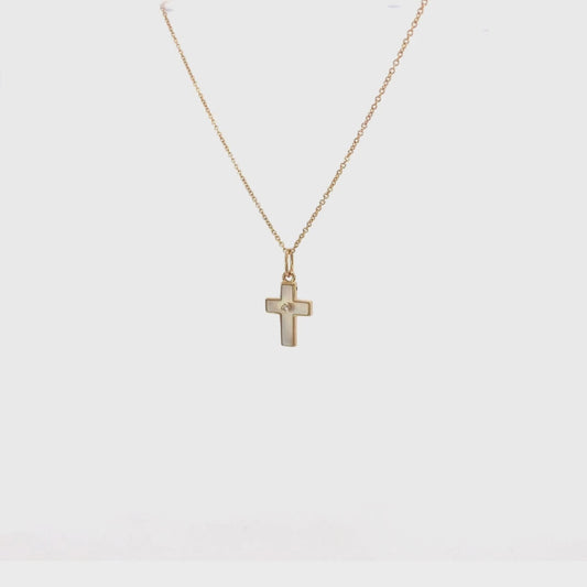 Cruz pequeña de oro 14 K con madre perla y circonia al centro